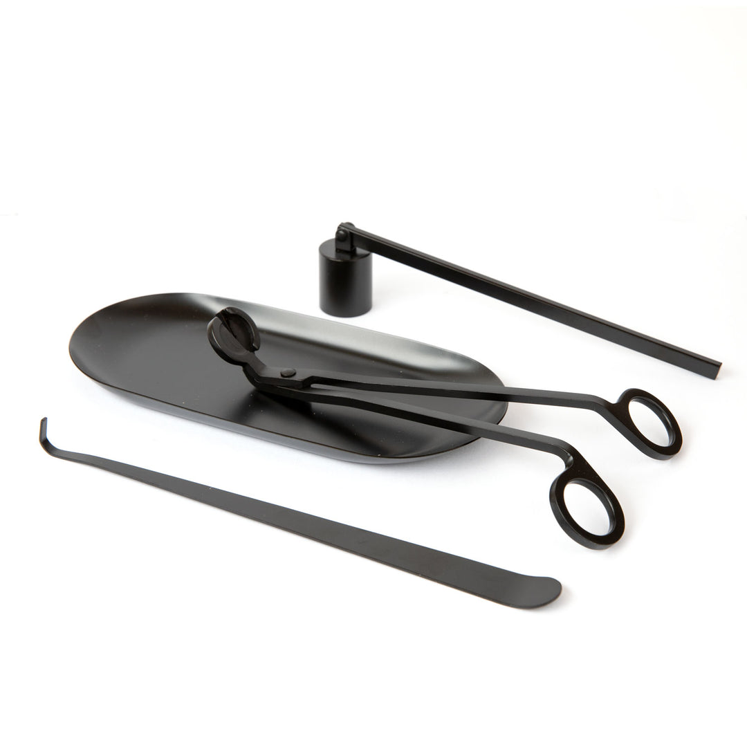 Black candle care kit with wick trimmer, candle snuffer, and wick dipper on a matching tray - essential candle accessories for maintaining home fragrance and extending candle life